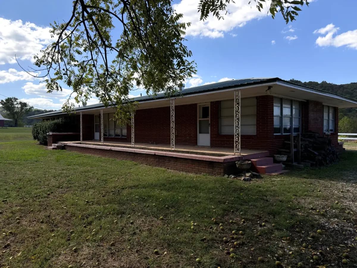 Exterior of the Brick House with covered porch at Sanctuary Ranch, Arkansas
