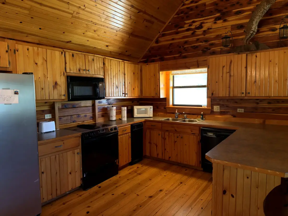 Full kitchen with knotty-pine cabinets in the Cabela Cabin