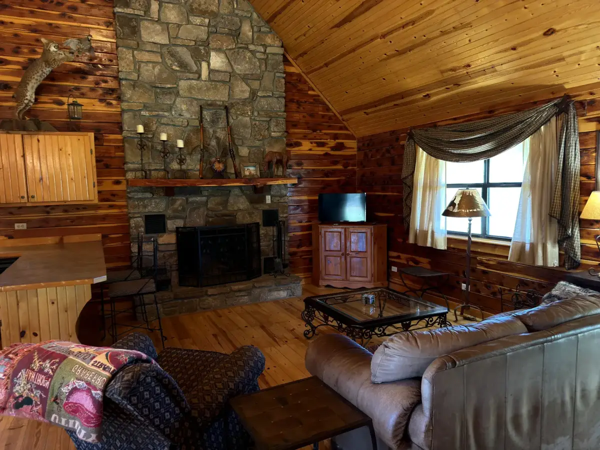 Living room with stone fireplace in the Cabela Cabin